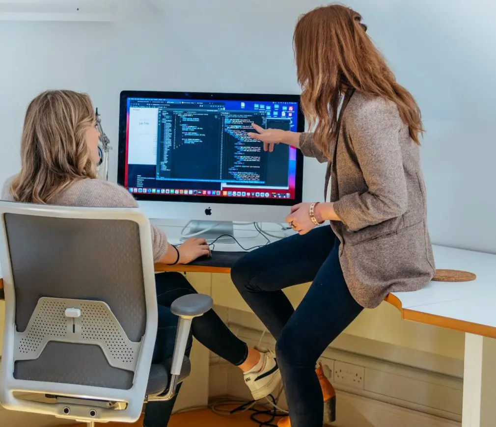Two members of the Maverick team reviewing a website build together